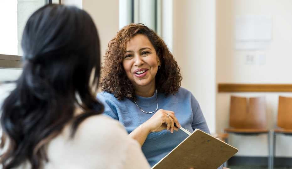 Two women discussing things at work.